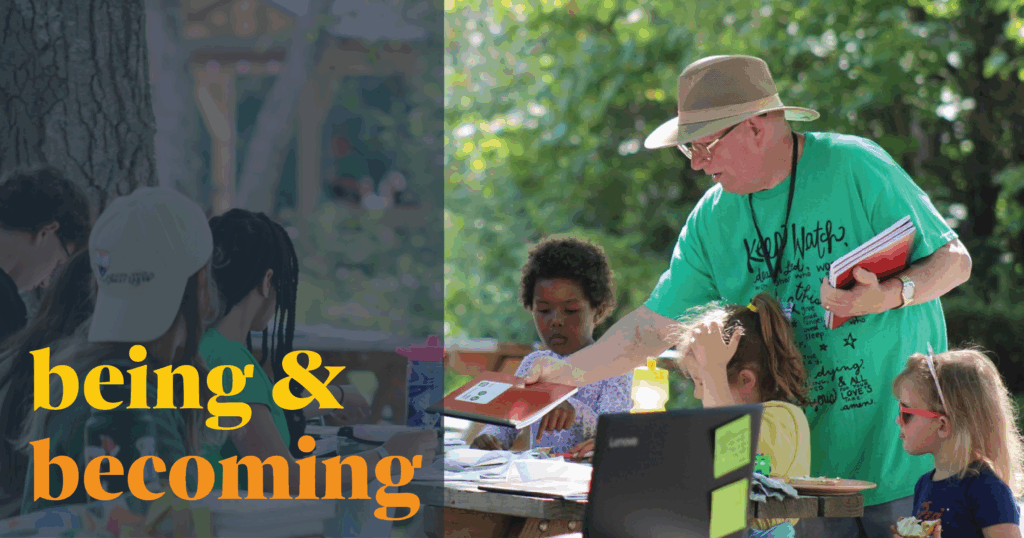 Image Description: Deacon Tom Smith hands out materials to day campers at Camp Chickagami who are seated at picnic tables outdoors on a sunny day. On the left side of the image is a semi-transparent dark blue color block with bold yellow and rich orange text that reads, "being & becoming."