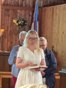 Image description: Kayleigh Gregg addresses the congregation.